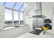 Modern white kitchen with stainless steel appliances and city views at 2828 Peachtree Nw Rd # Ph3300, Atlanta, GA 30305