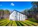 Modern farmhouse exterior with wood siding and large windows at 279 Laura Cir, Bowdon, GA 30108