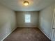 Bright bedroom featuring a window with blinds and carpeted floor at 194 Spring Leaf Dr, Dallas, GA 30157