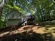 Back of house with deck and wooded view at 194 Spring Leaf Dr, Dallas, GA 30157