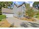 Gray house with attached garage and manicured landscaping at 7445 Talbot, Sandy Springs, GA 30328