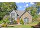 Two-story house with stone facade and lush green lawn at 7445 Talbot, Sandy Springs, GA 30328