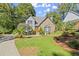 Two-story house with stone accents and landscaped yard at 7445 Talbot, Sandy Springs, GA 30328