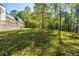 Large backyard with green grass, trees and deck at 5440 Shady Grove Rd, Cumming, GA 30041