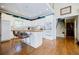 Modern kitchen with white cabinets, hardwood floors and teal accents at 5440 Shady Grove Rd, Cumming, GA 30041