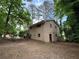 The backyard view showcases the home's exterior and tree-filled surroundings at 3715 Leisure Ln, College Park, GA 30349