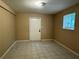 The basement space features tiled floors, a window, and a walkout door at 3715 Leisure Ln, College Park, GA 30349