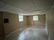 A basement room includes neutral walls, tile floors, and two windows at 3715 Leisure Ln, College Park, GA 30349