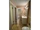 Bathroom featuring a white vanity sink, vinyl floor, and an open doorway to bedroom at 3715 Leisure Ln, College Park, GA 30349