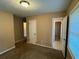 A cozy bedroom features neutral walls, a ceiling light, and multiple doorways at 3715 Leisure Ln, College Park, GA 30349