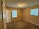 A bedroom has neutral walls, carpeting, and natural light from two windows at 3715 Leisure Ln, College Park, GA 30349