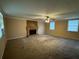 Spacious living room featuring a brick fireplace and abundant natural light from multiple windows at 3715 Leisure Ln, College Park, GA 30349