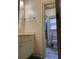 This bathroom has a sink and cabinet, and a view of the toilet and shower in the background at 3450 Camellia Ln, Suwanee, GA 30024