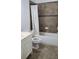 Well-lit bathroom with dark tile flooring, a bathtub with white curtain, and a white vanity, providing a clean space at 3450 Camellia Ln, Suwanee, GA 30024