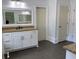 Well-lit bathroom featuring a granite countertop vanity with gray tile flooring at 3450 Camellia Ln, Suwanee, GA 30024