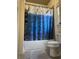 A well-lit bathroom shows a full shower/tub, toilet and dolphin-themed shower curtain at 3450 Camellia Ln, Suwanee, GA 30024