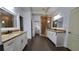 Spacious bathroom with double vanity, granite countertops, stand alone shower and dark tile flooring at 3450 Camellia Ln, Suwanee, GA 30024