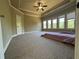 Large bedroom with plush carpet, tray ceiling, and natural light from multiple windows at 3450 Camellia Ln, Suwanee, GA 30024