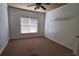 Sunlit bedroom with a ceiling fan, neutral paint, and a large window that allows for an airy and inviting space at 3450 Camellia Ln, Suwanee, GA 30024