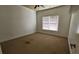 Cozy bedroom featuring a ceiling fan and a window, providing a comfortable and well-lit environment at 3450 Camellia Ln, Suwanee, GA 30024