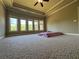 Spacious bedroom features plush carpet, tray ceilings, and ample natural light from large windows at 3450 Camellia Ln, Suwanee, GA 30024