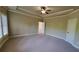 Spacious bedroom featuring a tray ceiling and multiple windows, providing an airy and bright living space at 3450 Camellia Ln, Suwanee, GA 30024