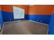 Vibrant bedroom with two-toned blue and orange walls and a large window, creating a unique and playful atmosphere at 3450 Camellia Ln, Suwanee, GA 30024