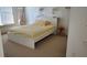 Minimalist bedroom with a platform bed, a small side table, and white walls for a serene and modern aesthetic at 3450 Camellia Ln, Suwanee, GA 30024