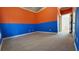 Unique bedroom featuring two-toned blue and orange walls, adding a playful design element to the living space at 3450 Camellia Ln, Suwanee, GA 30024
