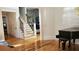 Elegant foyer with gleaming hardwood floors, piano, and staircase leading to upper floors at 3450 Camellia Ln, Suwanee, GA 30024