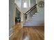 Hardwood flooring and staircase in the home's foyer. Large window provides great natural light at 3450 Camellia Ln, Suwanee, GA 30024