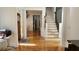 Inviting foyer features hardwood floors, staircase, and access to multiple rooms at 3450 Camellia Ln, Suwanee, GA 30024