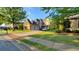 Beautiful brick home featuring a manicured lawn and a spacious driveway leading to a three-car garage at 3450 Camellia Ln, Suwanee, GA 30024