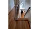 Hallway with hardwood flooring, showcasing trim and a glimpse of the piano room at 3450 Camellia Ln, Suwanee, GA 30024