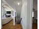 Hallway with staircase leading to basement, hardwood floors, view to living room and dining room at 3450 Camellia Ln, Suwanee, GA 30024