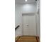 Bright hallway featuring hardwood floors and white double doors for a classic aesthetic at 3450 Camellia Ln, Suwanee, GA 30024