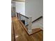 Hallway featuring hardwood floors and stairs leading downstairs offers a stylish transition at 3450 Camellia Ln, Suwanee, GA 30024