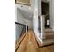 Hallway boasts gleaming hardwood floors, trim accents, and a view into a bedroom with a ceiling fan at 3450 Camellia Ln, Suwanee, GA 30024