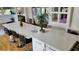 Bright kitchen featuring a large island with seating, white countertops, and hardwood floors at 3450 Camellia Ln, Suwanee, GA 30024