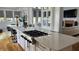 Modern kitchen with a large center island featuring a cooktop and breakfast bar seating at 3450 Camellia Ln, Suwanee, GA 30024