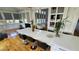 Open concept kitchen with a large island, seating, and views to a sunroom and living area at 3450 Camellia Ln, Suwanee, GA 30024
