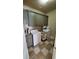 Well-equipped laundry room with gray cabinetry and modern appliances, enhancing the home's functionality at 3450 Camellia Ln, Suwanee, GA 30024