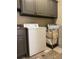 Functional laundry room equipped with a washer, dryer, and ample cabinet space at 3450 Camellia Ln, Suwanee, GA 30024