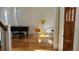 Bright living room featuring hardwood floors, a grand piano, and stylish decor at 3450 Camellia Ln, Suwanee, GA 30024