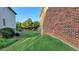 Brick house with a well-maintained lawn and mature trees next to a neighboring house at 3450 Camellia Ln, Suwanee, GA 30024