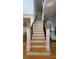 Elegant staircase with wooden steps, wrought iron spindles, and white posts at 3450 Camellia Ln, Suwanee, GA 30024