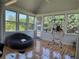 Bright sunroom with floor to ceiling windows and hardwood floors offers a versatile living space at 3450 Camellia Ln, Suwanee, GA 30024
