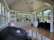 Vaulted sunroom with natural light, ceiling fan, and hardwood floors creates a serene atmosphere at 3450 Camellia Ln, Suwanee, GA 30024