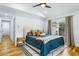 Inviting bedroom featuring a vaulted ceiling, ceiling fan, hardwood floors, and sliding glass doors at 1377 Oak Grove Dr, Decatur, GA 30033