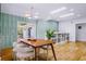 Elegant dining room with a modern light fixture, accent wall, and sliding glass doors at 1377 Oak Grove Dr, Decatur, GA 30033